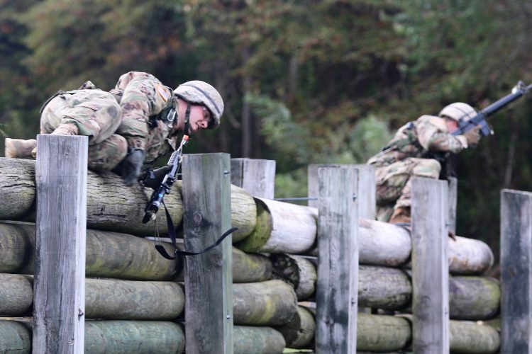 Ranger Challenge Cadets vault a wooden barrier