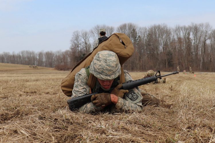 A Cadet high-crawls during the Arctic Ranger Challenge