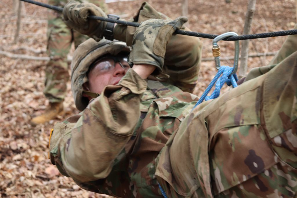 Cadet traverses a one-rope bridge during the Arctic Ranger Challenge